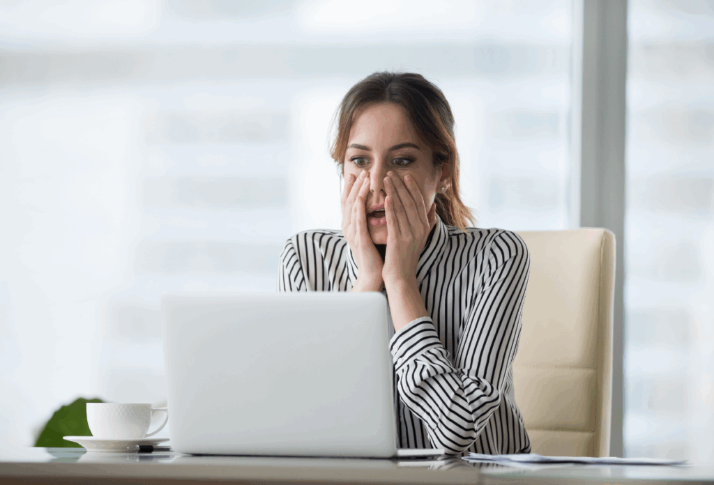 Woman looking shocked at her computer screen