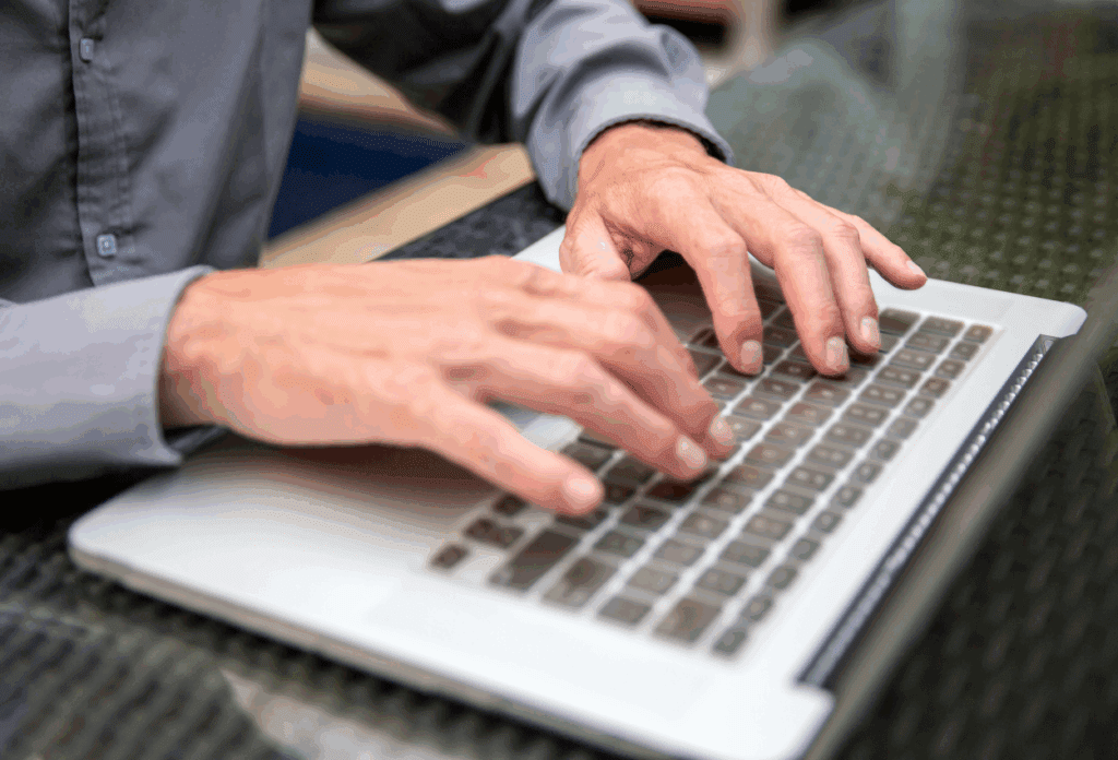 Person typing quickly on a computer, illustrating how fast responses aren't real support and don't always equal effective issue resolution.