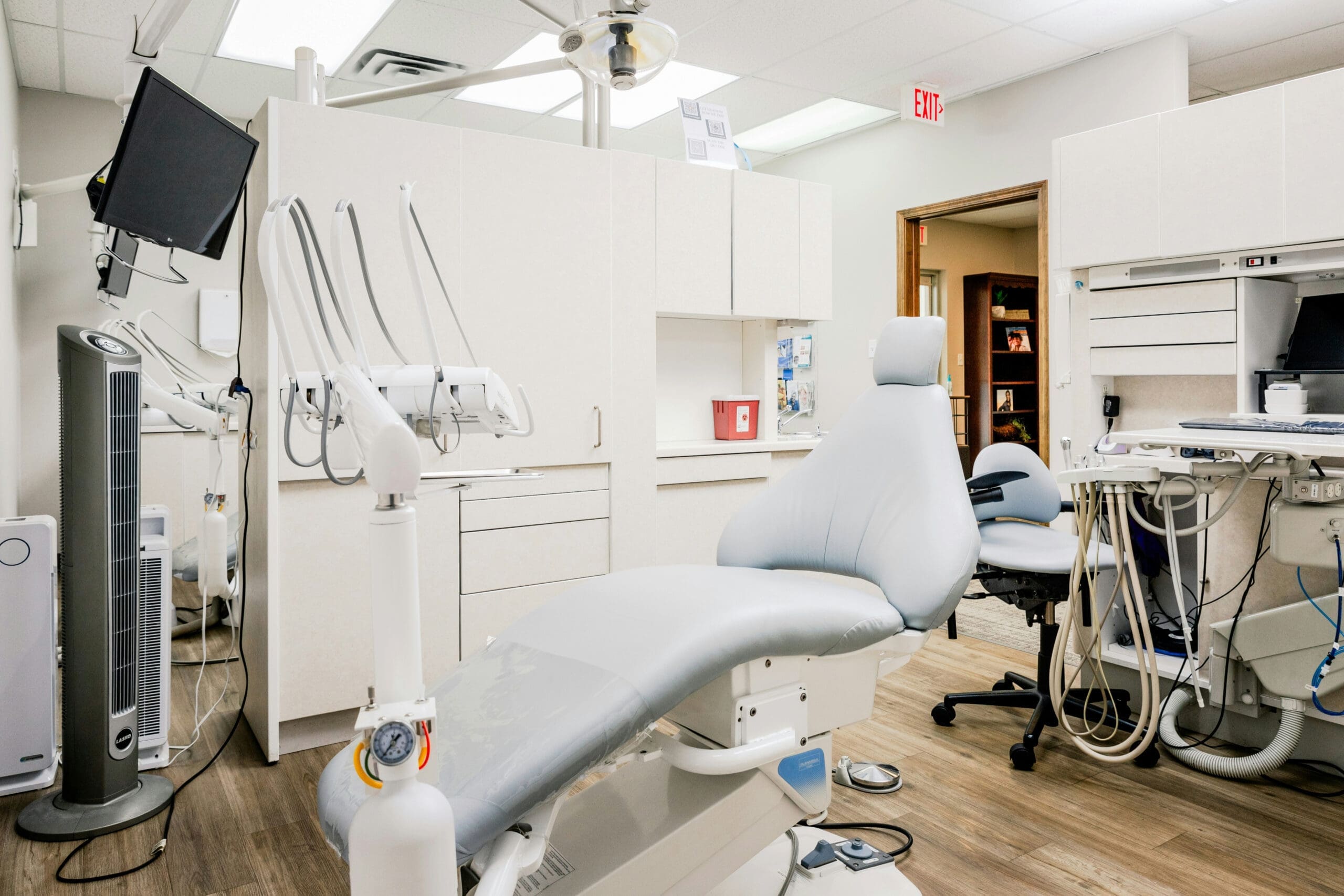 A modern dental chair in a clean, well-lit dental office.