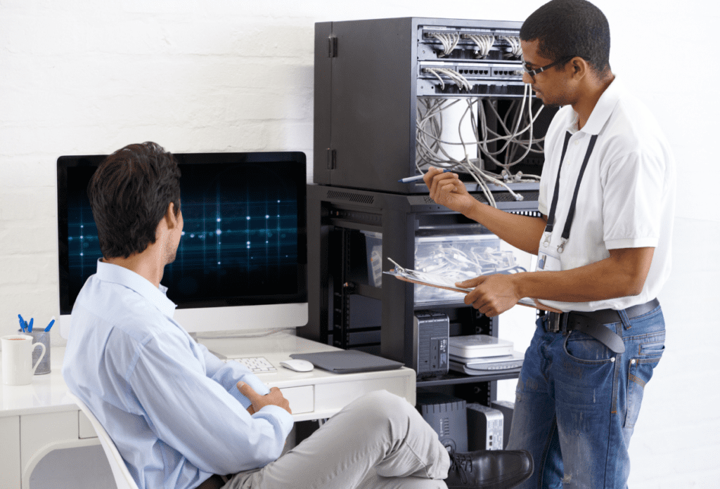 IT technician from a managed service provider assisting a client with server maintenance and network security.